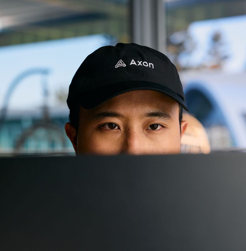 Official AppLovin photo showing a team member wearing an AXON cap